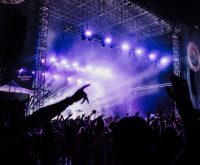 Escenario de concierto de rock con luces intensas y atmósfera energética en directo
