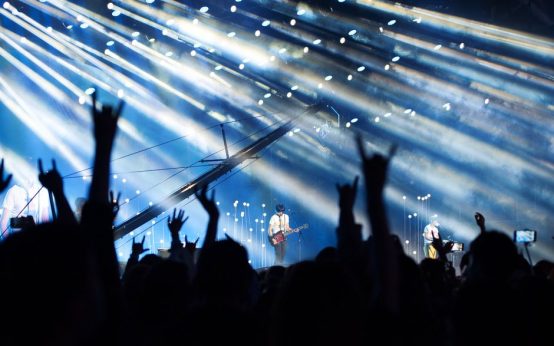 Atmósfera de concierto de metal con iluminación dramática y público entregado