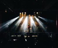 Escenario de concierto de rock con baterías y luces brillantes