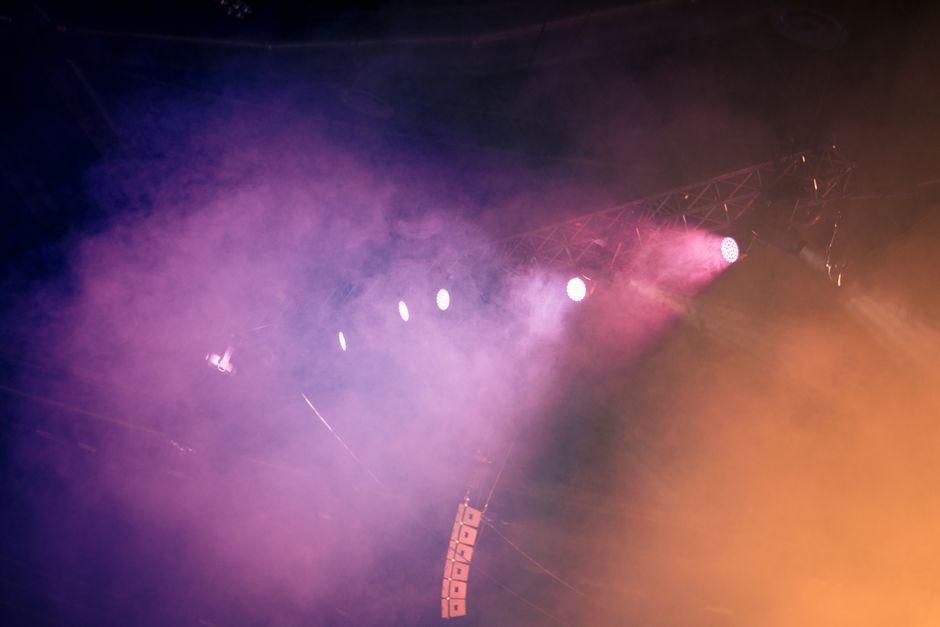 Escenario de concierto con luces coloridas evocando la atmósfera del funk y disco